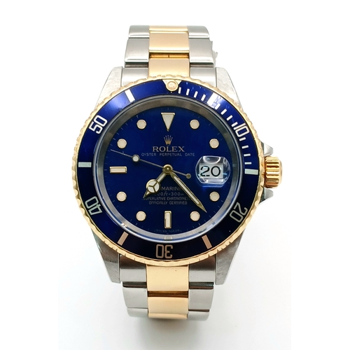 A Classic Rolex Bi-Metal Submariner Automatic Gents Watch. Model 16613. Gold and stainless steel bracelet. Stainless steel case with gold bezel - 40mm. Blue dial with date window. In Working order. Comes with guarantee and booklets in Rolex wallet. Note: Bracelet is slightly short so a couple of links need to be added for the average/larger wrist. TTB057.