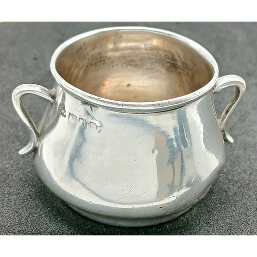 575 - An Antique Sterling Silver Twin-Handled Cup. London hallmarks, 1903. Approx 5.5cm x 4cm. Total weigh... 