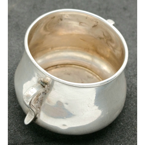 575 - An Antique Sterling Silver Twin-Handled Cup. London hallmarks, 1903. Approx 5.5cm x 4cm. Total weigh... 