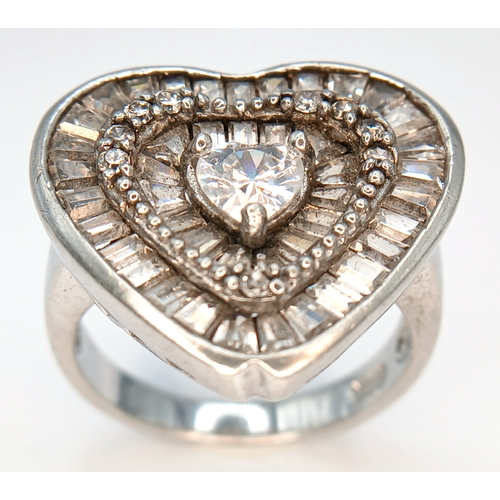 1241 - A 925 Silver Heart Shaped Clear Stone Cluster Ring. Heart shaped centre with clear stone set halo an... 