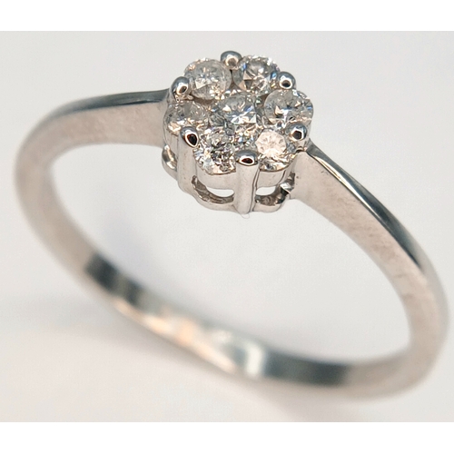 573 - A 9K WHITE GOLD, DIAMOND SET CLUSTER RING. 0.25CTW. 1.8G, SIZE Q. SC 2039
