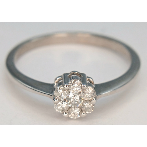 573 - A 9K WHITE GOLD, DIAMOND SET CLUSTER RING. 0.25CTW. 1.8G, SIZE Q. SC 2039