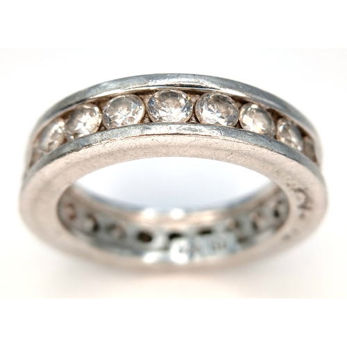 1219 - A 925 Silver Clear Stone Set Eternity Ring. Size O 1/2. Total weight: 7.24g.