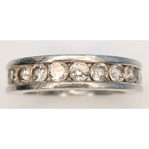 1219 - A 925 Silver Clear Stone Set Eternity Ring. Size O 1/2. Total weight: 7.24g.