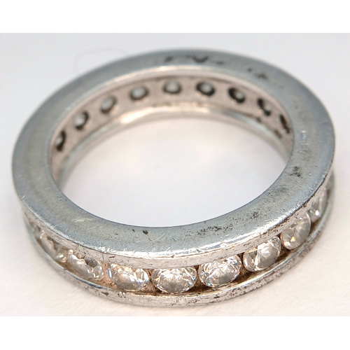 1219 - A 925 Silver Clear Stone Set Eternity Ring. Size O 1/2. Total weight: 7.24g.