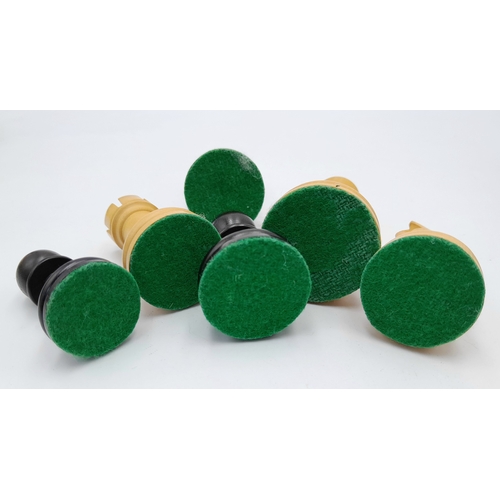 597 - An Ebony and Boxwood Set of Chess Pieces. All having a felt bottom and of Indian origin. 3.25