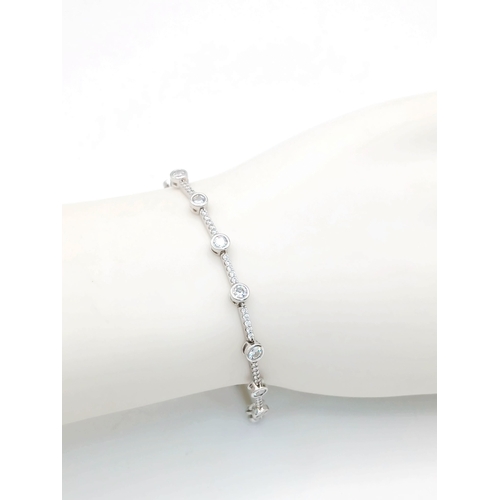 578 - A Pretty Sterling Silver Cubic Zirconia Tennis Bracelet-19.5cm Length. 4mm wide and set with two siz... 