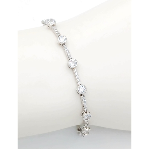 578 - A Pretty Sterling Silver Cubic Zirconia Tennis Bracelet-19.5cm Length. 4mm wide and set with two siz... 