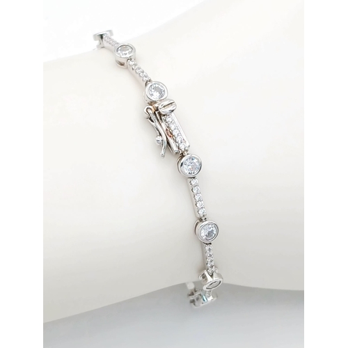 578 - A Pretty Sterling Silver Cubic Zirconia Tennis Bracelet-19.5cm Length. 4mm wide and set with two siz... 