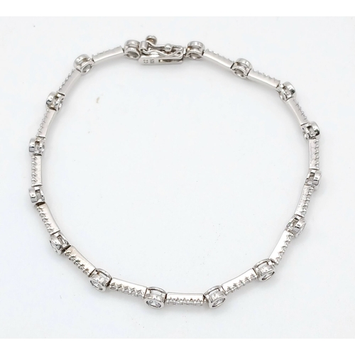 578 - A Pretty Sterling Silver Cubic Zirconia Tennis Bracelet-19.5cm Length. 4mm wide and set with two siz... 