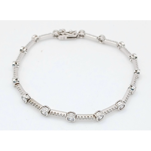 578 - A Pretty Sterling Silver Cubic Zirconia Tennis Bracelet-19.5cm Length. 4mm wide and set with two siz... 