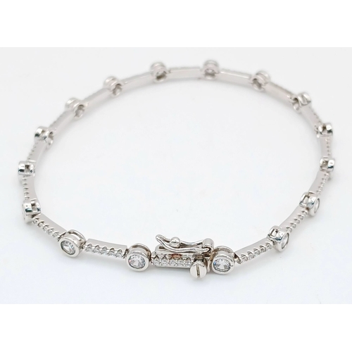 578 - A Pretty Sterling Silver Cubic Zirconia Tennis Bracelet-19.5cm Length. 4mm wide and set with two siz... 