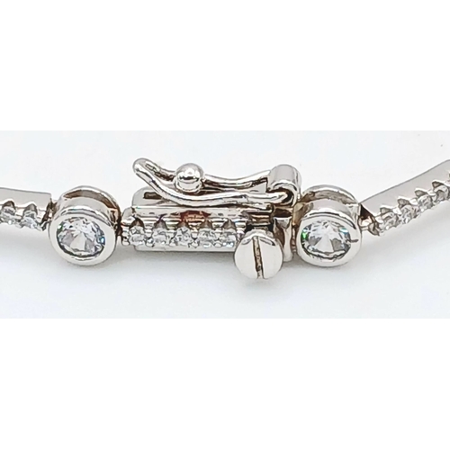 578 - A Pretty Sterling Silver Cubic Zirconia Tennis Bracelet-19.5cm Length. 4mm wide and set with two siz... 