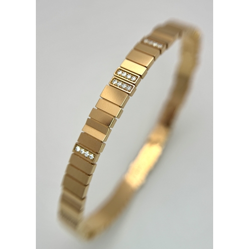 12 - A Dior 18K rose gold and diamond bangle. Total weight 19.676G. Measure: 6cmx4cm. Comes with card of ... 