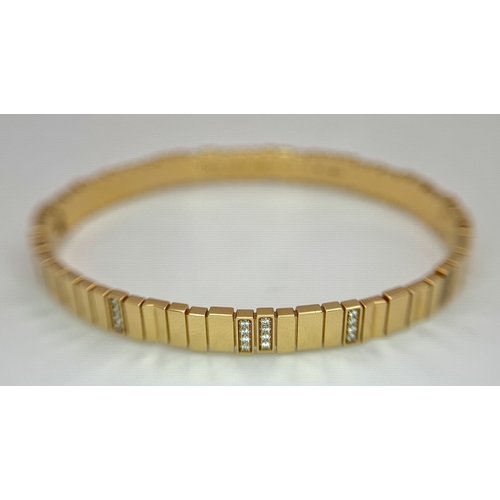 12 - A Dior 18K rose gold and diamond bangle. Total weight 19.676G. Measure: 6cmx4cm. Comes with card of ... 