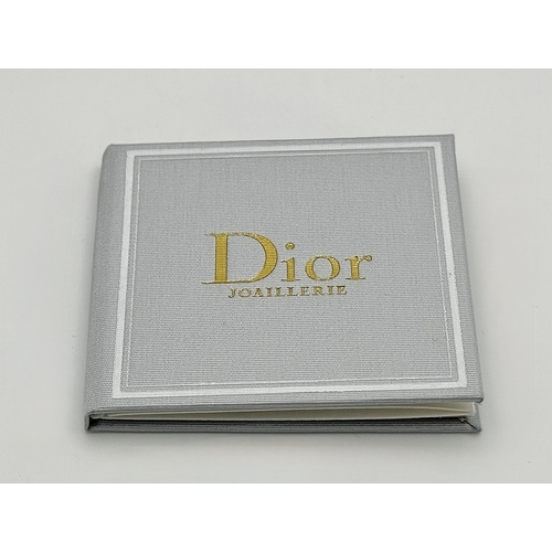12 - A Dior 18K rose gold and diamond bangle. Total weight 19.676G. Measure: 6cmx4cm. Comes with card of ... 