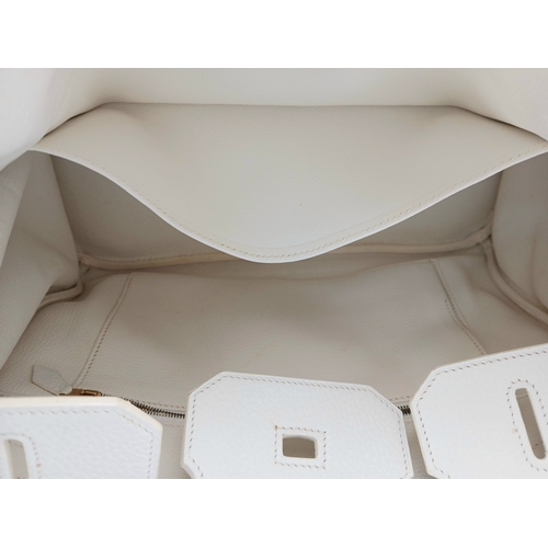 47 - An Hermès White Togo Birkin 35 Handbag. White grained calfskin leather exterior with gold-toned hard... 