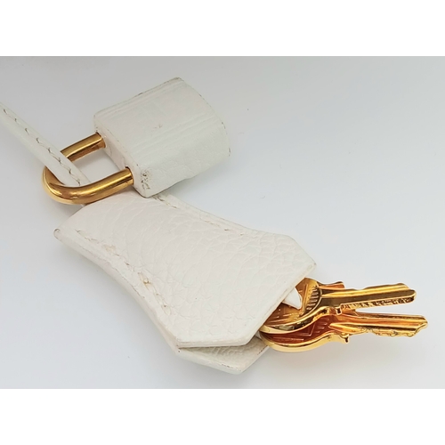 47 - An Hermès White Togo Birkin 35 Handbag. White grained calfskin leather exterior with gold-toned hard... 