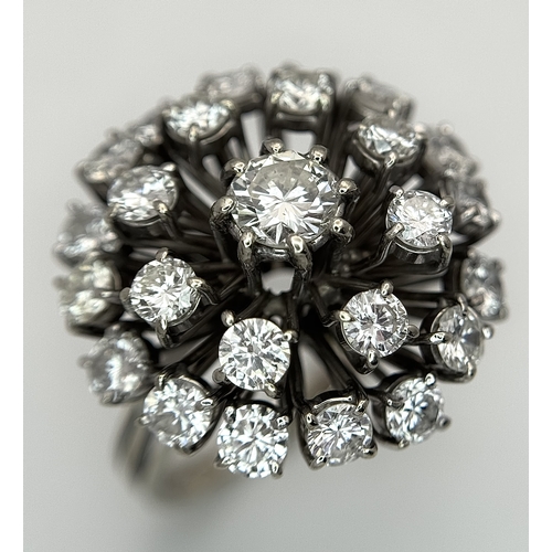51 - An 18k Gold and Diamond Starburst Cluster Cocktail Ring. c. 4ctw of round brilliants cut diamonds ha... 