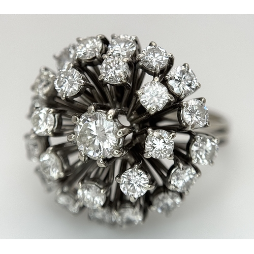 51 - An 18k Gold and Diamond Starburst Cluster Cocktail Ring. c. 4ctw of round brilliants cut diamonds ha... 