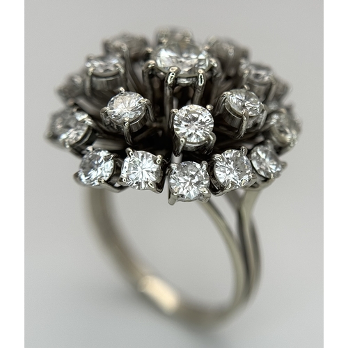 51 - An 18k Gold and Diamond Starburst Cluster Cocktail Ring. c. 4ctw of round brilliants cut diamonds ha... 