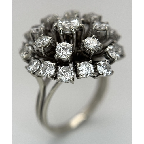 51 - An 18k Gold and Diamond Starburst Cluster Cocktail Ring. c. 4ctw of round brilliants cut diamonds ha... 
