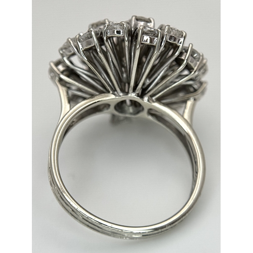 51 - An 18k Gold and Diamond Starburst Cluster Cocktail Ring. c. 4ctw of round brilliants cut diamonds ha... 