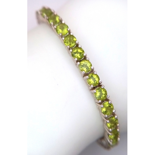 571 - A Sterling Silver Peridot Set Tennis Bracelet-19.5cm Length. Set with Forty-Two 3.5mm Round Cut Peri... 