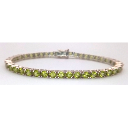 571 - A Sterling Silver Peridot Set Tennis Bracelet-19.5cm Length. Set with Forty-Two 3.5mm Round Cut Peri... 