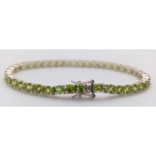 571 - A Sterling Silver Peridot Set Tennis Bracelet-19.5cm Length. Set with Forty-Two 3.5mm Round Cut Peri... 