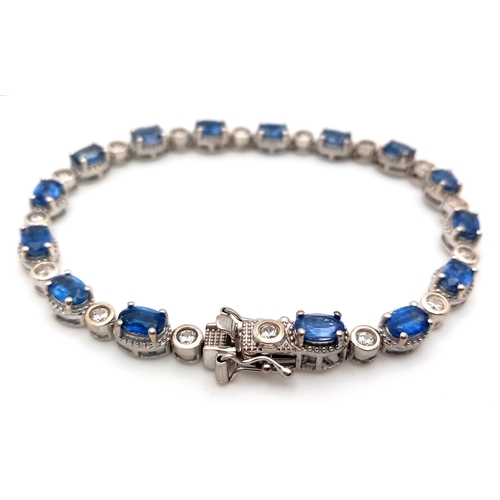 592 - A Beautiful Sterling Silver Blue and White Topaz Tennis Bracelet-19cm Length. Set with 6 x 4mm Oval ... 