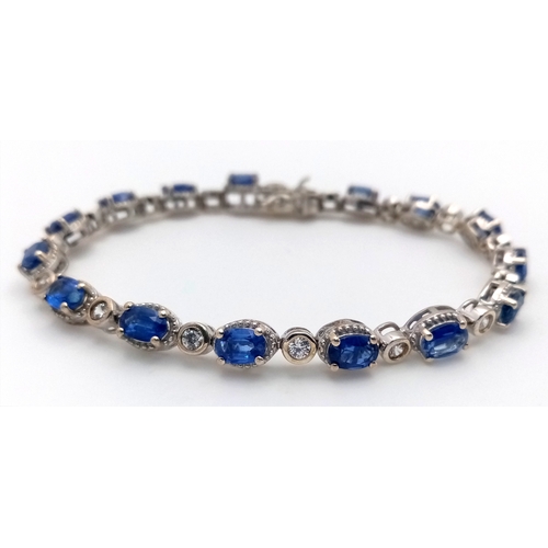 592 - A Beautiful Sterling Silver Blue and White Topaz Tennis Bracelet-19cm Length. Set with 6 x 4mm Oval ... 