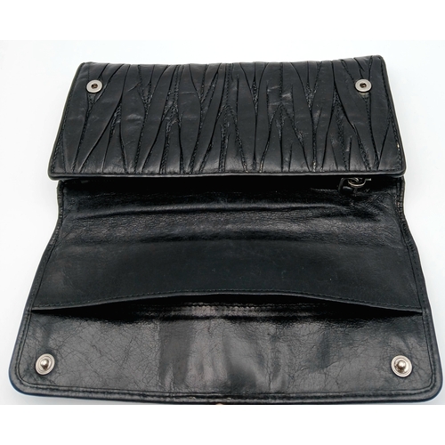 579 - A Miu Miu Nappa Matelassé Flap Wallet. Black matelassé pleated leather exterior with silver-toned lo... 