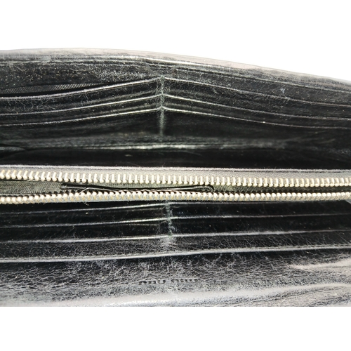 579 - A Miu Miu Nappa Matelassé Flap Wallet. Black matelassé pleated leather exterior with silver-toned lo... 