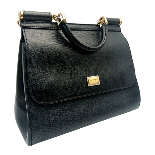 565 - A Dolce & Gabbana Dauphine Small Miss Sicily Satchel Bag. Black grained leather exterior with gold-t... 