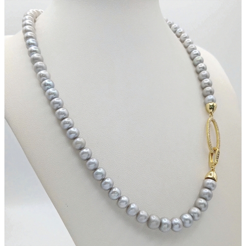 1258 - A Silver-Tone Freshwater Pearl Necklace with Gilded Clasp. 6/7mm pearls. 44cm length. MK23