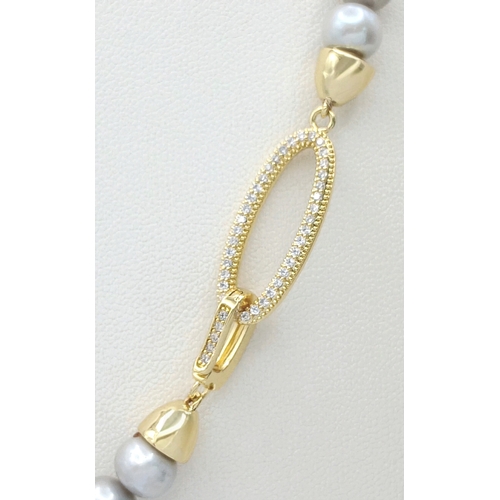 1258 - A Silver-Tone Freshwater Pearl Necklace with Gilded Clasp. 6/7mm pearls. 44cm length. MK23