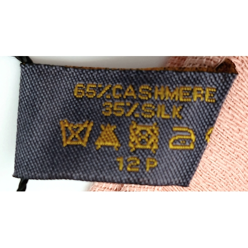558 - A Fendi Pink FF Monogram Scarf. Soft pink fabric with tonal FF monogram throughout and fringed edges... 