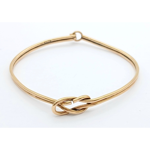 61 - A 9K Yellow Gold Bangle Bracelet. Twin row knot design. 55mm inner diameter. 7.7g.