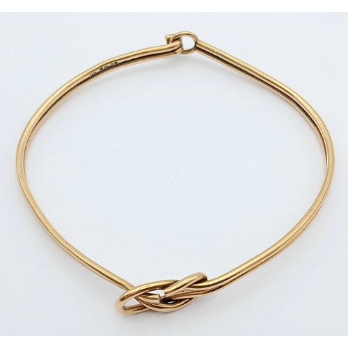 61 - A 9K Yellow Gold Bangle Bracelet. Twin row knot design. 55mm inner diameter. 7.7g.
