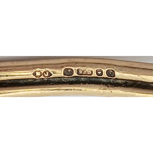61 - A 9K Yellow Gold Bangle Bracelet. Twin row knot design. 55mm inner diameter. 7.7g.