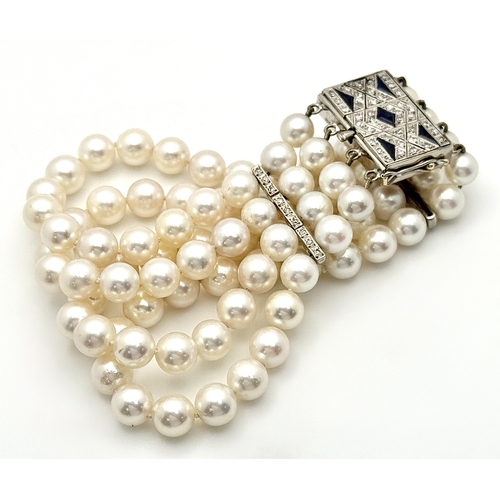 1253 - A FOUR ROW, 8MM AKOYA DESIGNER PEARL BRACELET. WITH A 14K WHITE GOLD, ART DECO DESIGN, DIAMOND AND S... 