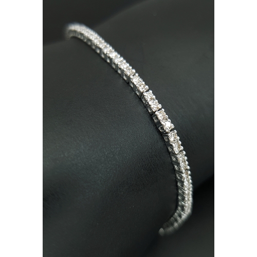 1260 - AN 18K WHITE GOLD, DIAMOND SET, TENNIS LINE BRACELET. 1.75CTW. 7.6G. SC 1068