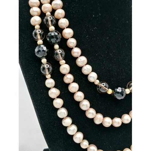 1205 - An attractive rope length Pink Freshwater Pearl Necklace with Black and Brown Bead Spacers. Approx 1... 