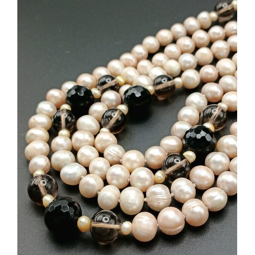 1205 - An attractive rope length Pink Freshwater Pearl Necklace with Black and Brown Bead Spacers. Approx 1... 