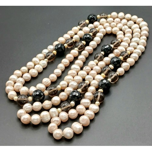 1205 - An attractive rope length Pink Freshwater Pearl Necklace with Black and Brown Bead Spacers. Approx 1... 