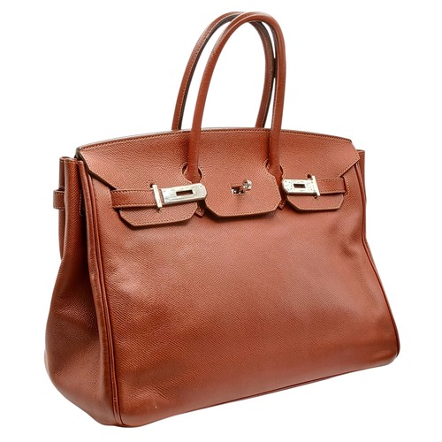 33 - An Hermès Brick Red Courchevel Birkin 35 Handbag. Brick red Courchevel leather exterior with silver-... 