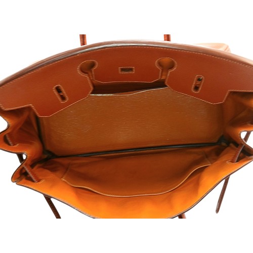 33 - An Hermès Brick Red Courchevel Birkin 35 Handbag. Brick red Courchevel leather exterior with silver-... 