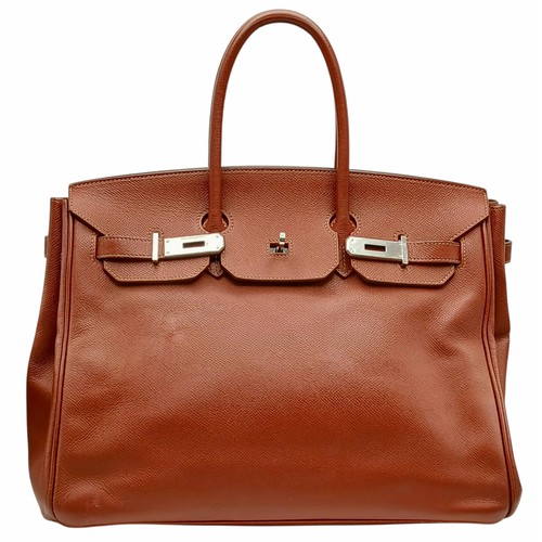 33 - An Hermès Brick Red Courchevel Birkin 35 Handbag. Brick red Courchevel leather exterior with silver-... 