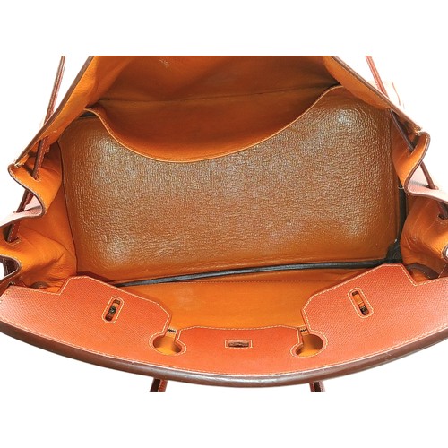33 - An Hermès Brick Red Courchevel Birkin 35 Handbag. Brick red Courchevel leather exterior with silver-... 